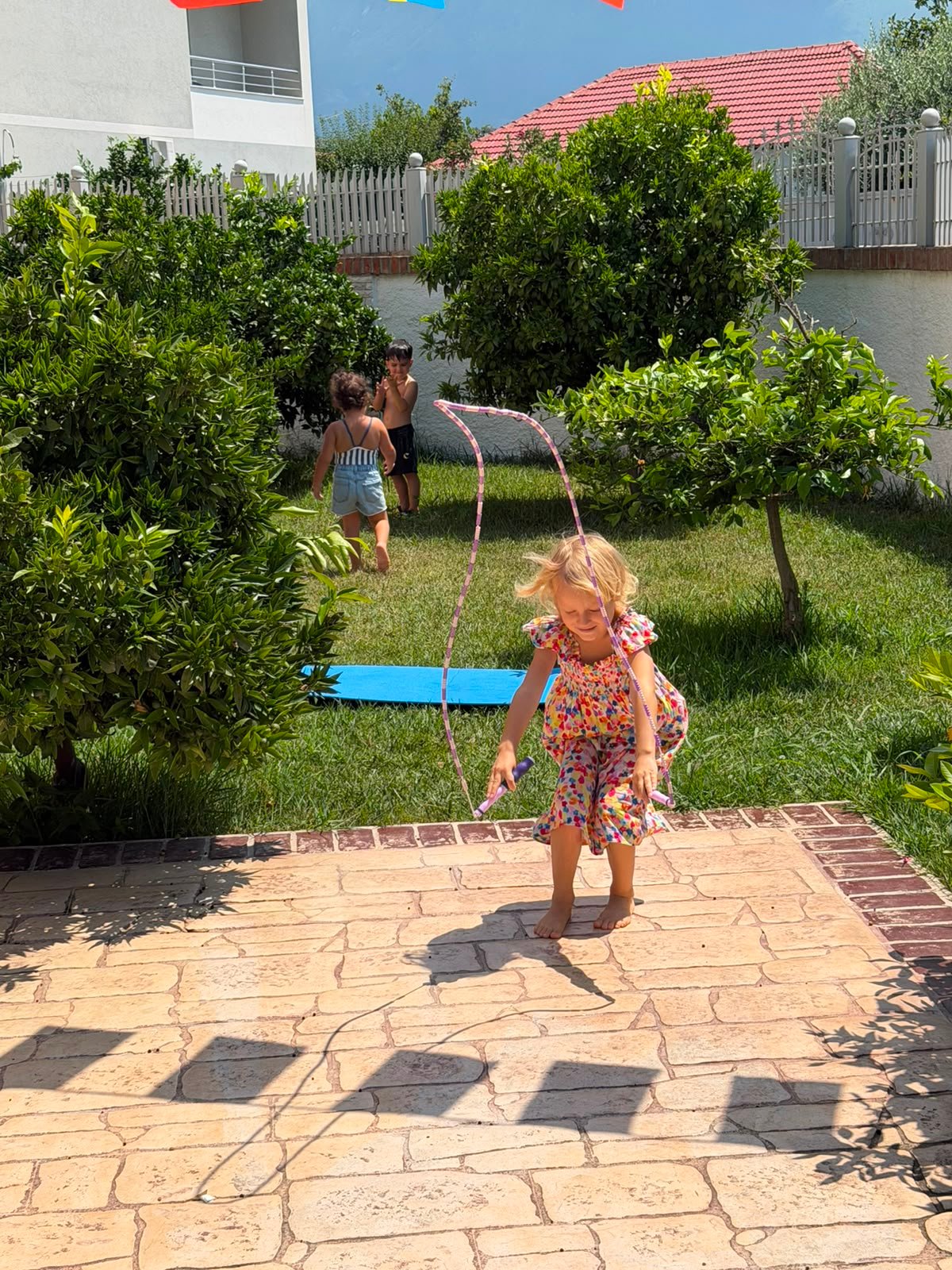 Children playing together by garden slide
